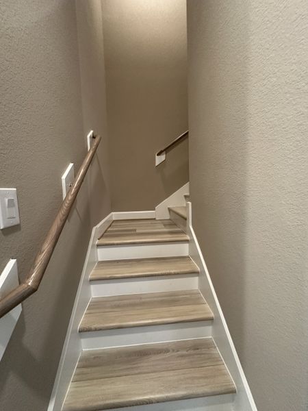A modern staircase with wooden steps and sleek railings, featuring soft neutral wall tones for a cozy ambiance. A modern staircase with wooden steps and sleek railings, featuring soft neutral wall tones for a cozy ambiance.