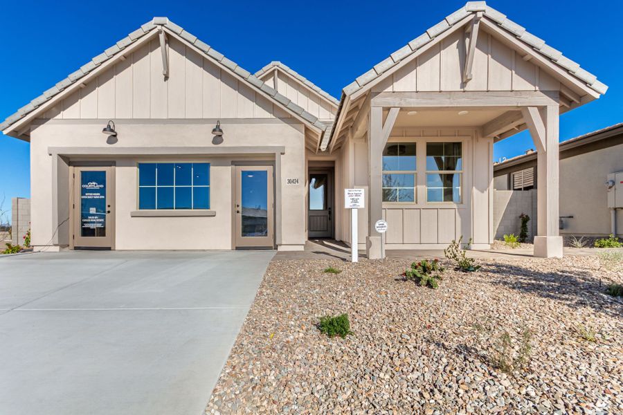 Front exterior of a home in the Agave Springs at Teravalis community, located in Buckeye, AZ (Image 14).