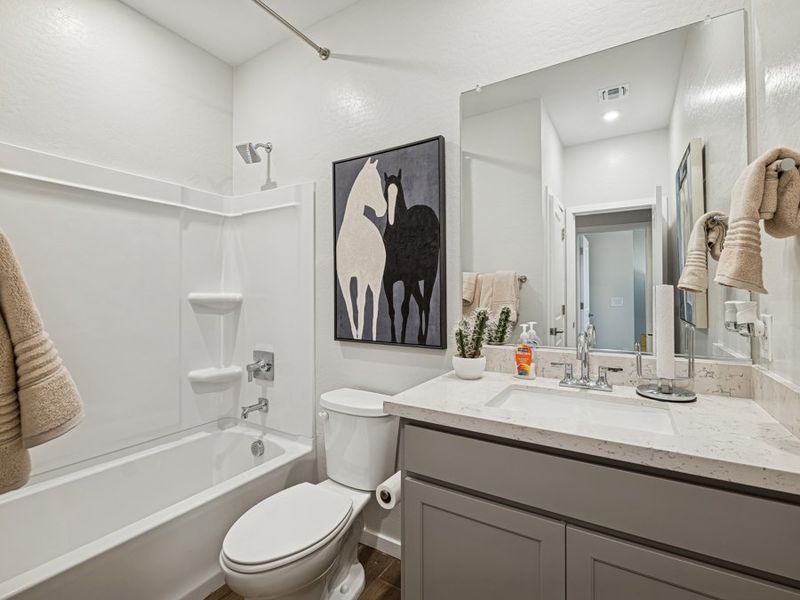 A bathroom with a large mirror.