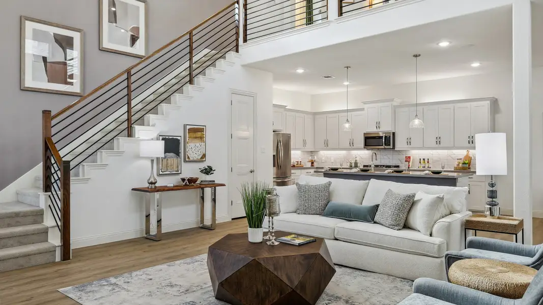 Exquisite open-plan layout with sleek staircase and airy kitchen in Solterra, Texas home.