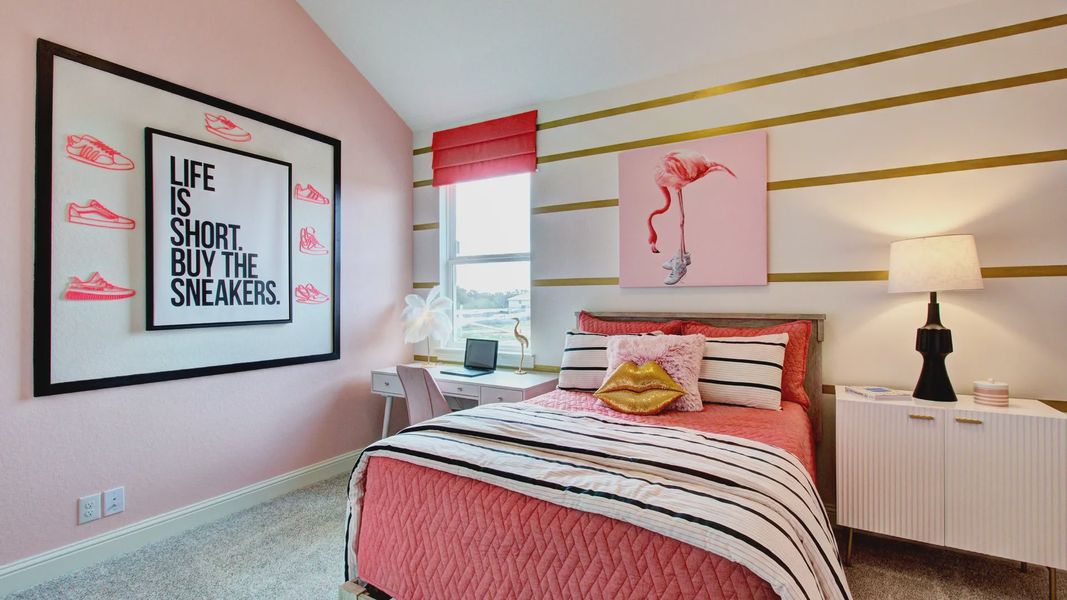 Chic pink decor meets modern furnishings in this Veranda community bedroom. Unique art and cozy textures enhance luxury.