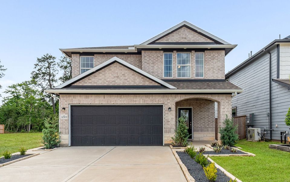 Front exterior of a home in the The Pines at Seven Coves community, located in Willis, TX (Image 2).