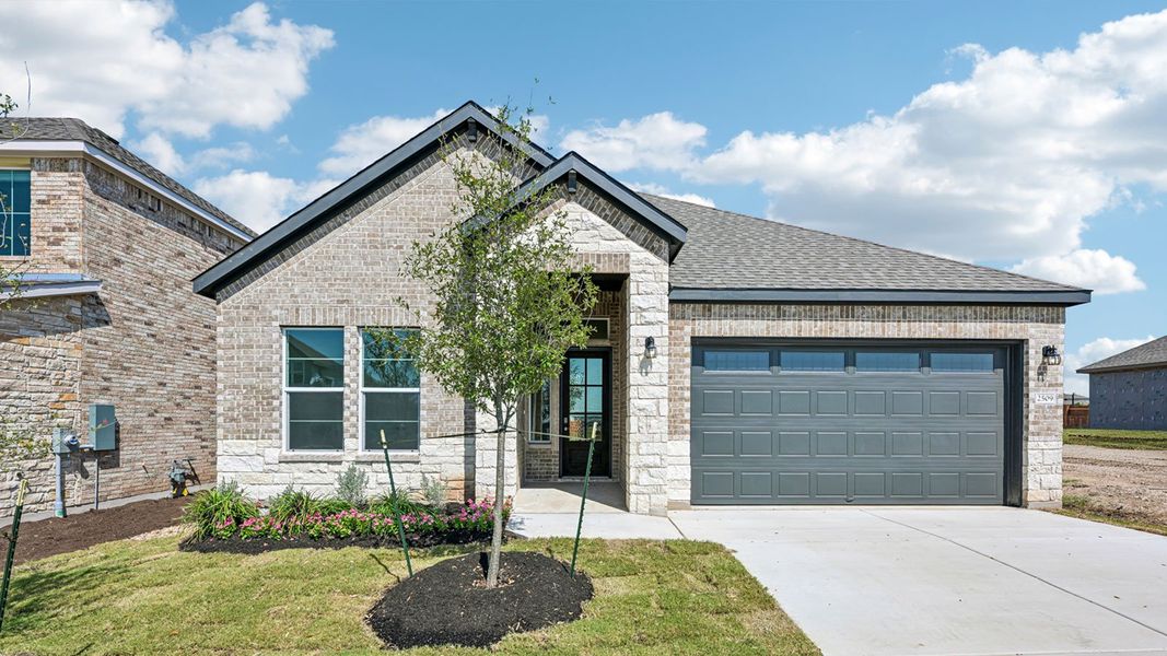 Front exterior of a home in the The Enclave at Bar W Ranch community, located in Leander, TX (Image 6).