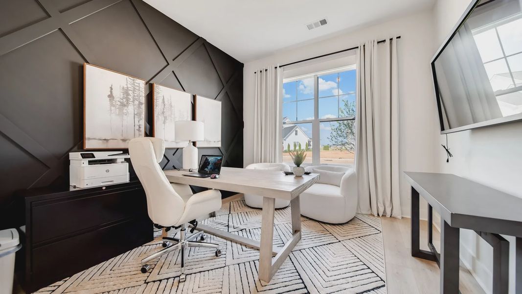 Experience sophistication with a bold black accent wall and airy design in Shelton Square.