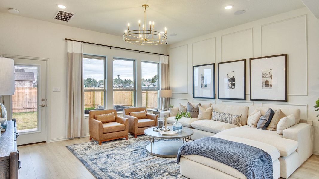 Opulent Opal Ranch living room with floor-to-ceiling windows and a chic chandelier.