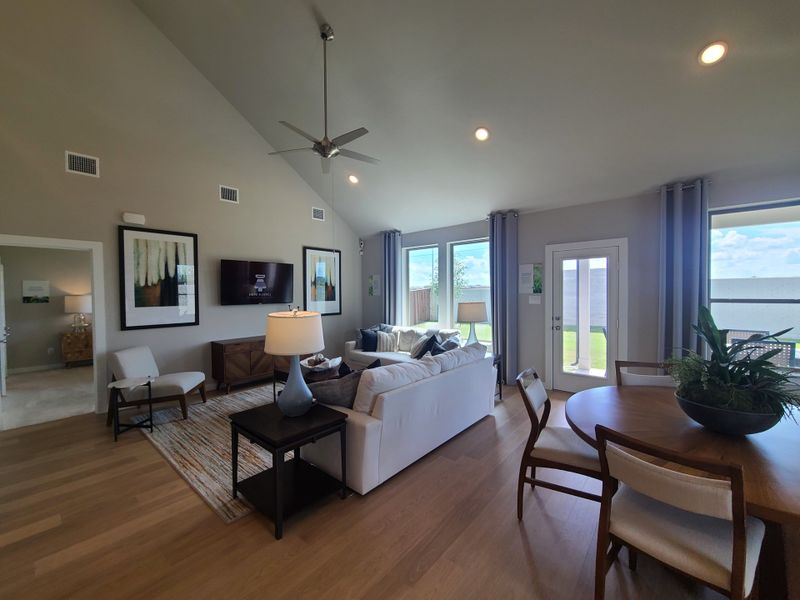 Spacious living area with high ceilings, modern furnishings, and large windows offering ample natural light. Spacious living area with high ceilings, modern furnishings, and large windows offering ample natural light.