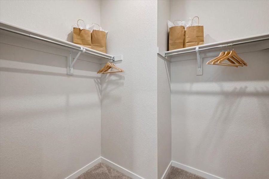 A white shelf with baskets on it. A white shelf with baskets on it.