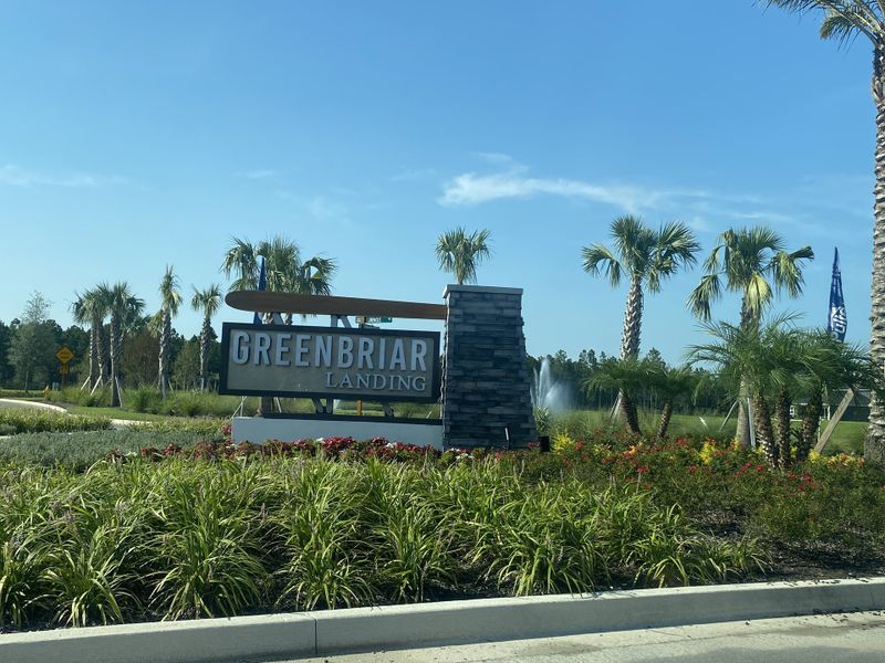 A welcoming entrance with a modern sign and lush landscaping at The Landings at Saint Johns by Pulte Homes (St. Johns, FL).