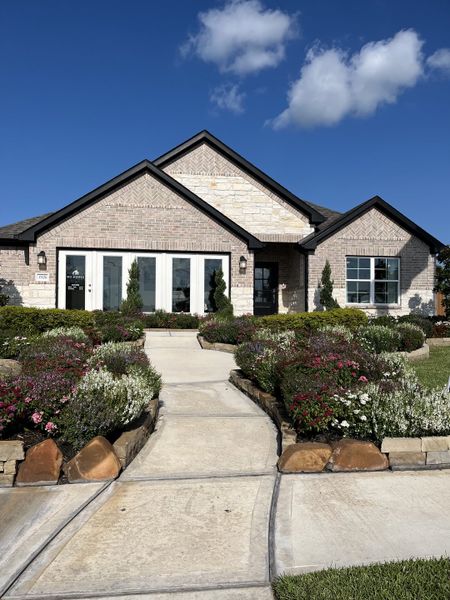A charming brick home with lush landscaping in Lago Mar by M/I Homes (Santa Fe, TX). A charming brick home with lush landscaping in Lago Mar by M/I Homes (Santa Fe, TX).