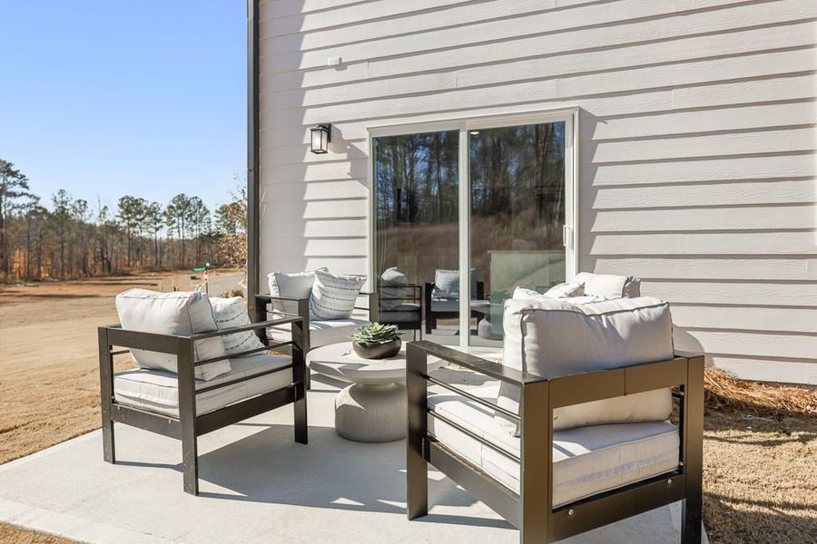 A deck with a chair and a table outside a house. A deck with a chair and a table outside a house.