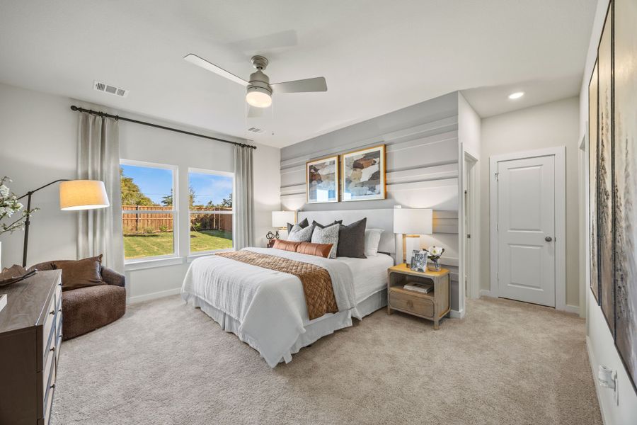 A bedroom with a large window.