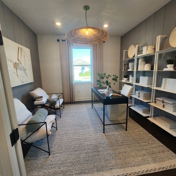 A cozy home office featuring chic shelving, a modern desk, and comfortable seating with a woven light fixture.