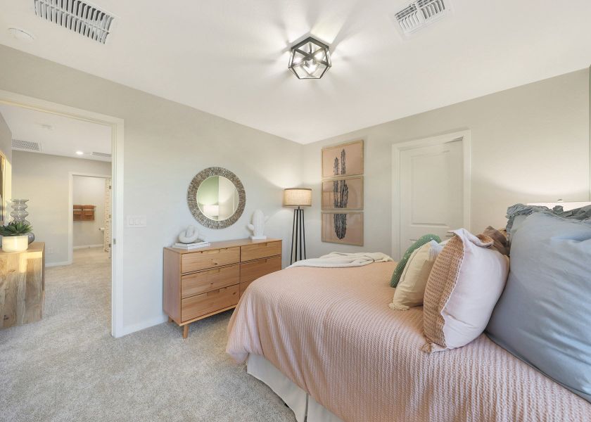 A bedroom with a bed and a mirror. A bedroom with a bed and a mirror.