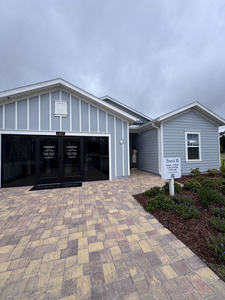Charming gray home with elegant entry and paver walkway in Seaton Creek: Seaton Creek 60s by Lennar (Jacksonville, FL).