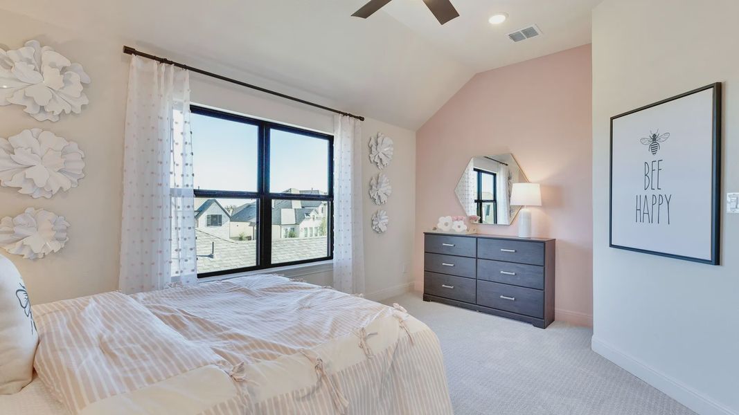 Discover the charm of a soft pink accent wall and high-end furnishings in Flora Community.