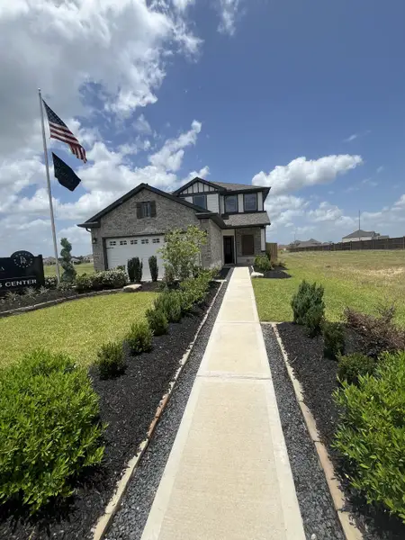 Charming brick home with manicured landscaping in Bluestem by First America Homes (Brookshire, TX). Charming brick home with manicured landscaping in Bluestem by First America Homes (Brookshire, TX).