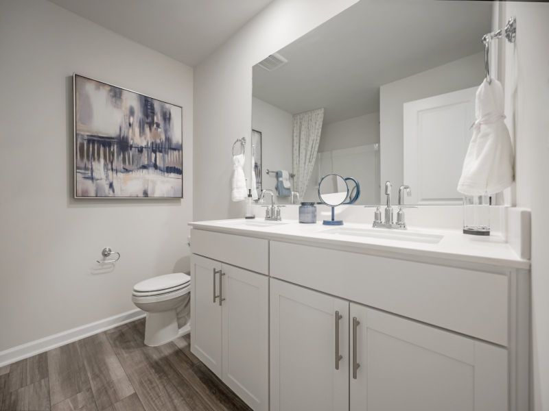 The secondary bathroom is nestled between the upstairs secondary bedrooms.