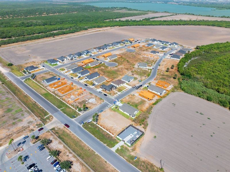 Aerial view of the The Heights at Riverbend II community in Brownsville, TX, showing layout and nearby surroundings (Image 11). Aerial view of the The Heights at Riverbend II community in Brownsville, TX, showing layout and nearby surroundings (Image 11).
