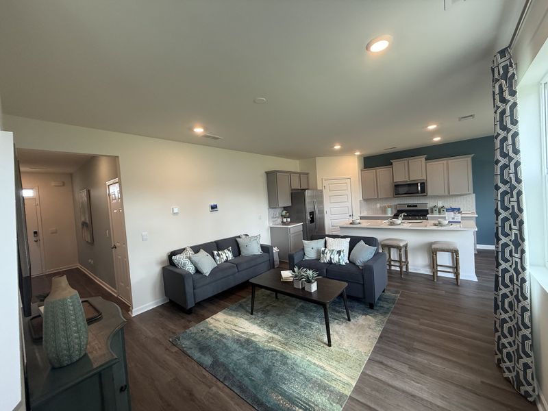 A cozy open-concept living area with contemporary furniture, a sleek kitchen, and stylish décor.