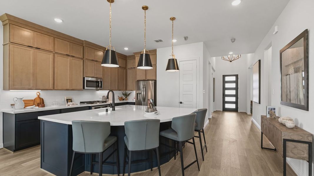 Exquisite Beamer Villas kitchen featuring a marble island, sleek hardwood floors, and chic pendant lighting. Exquisite Beamer Villas kitchen featuring a marble island, sleek hardwood floors, and chic pendant lighting.