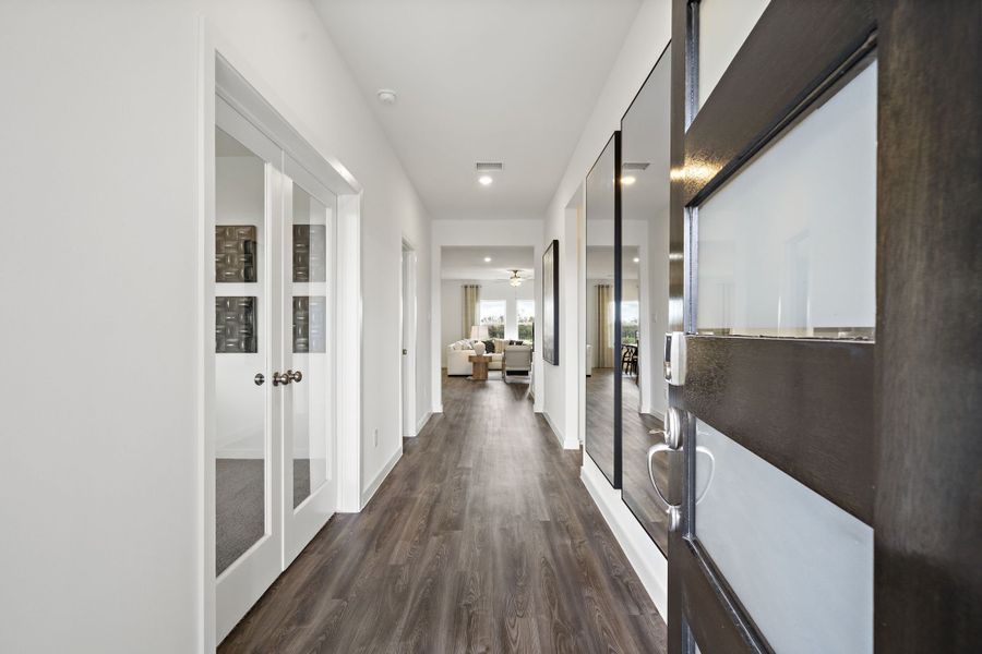 A hallway with white doors. A hallway with white doors.