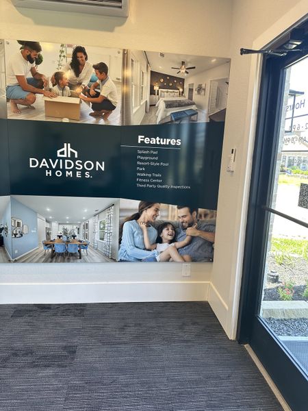 A promotional display featuring family moments and home features by Davidson Homes LLC at Sundance Cove.