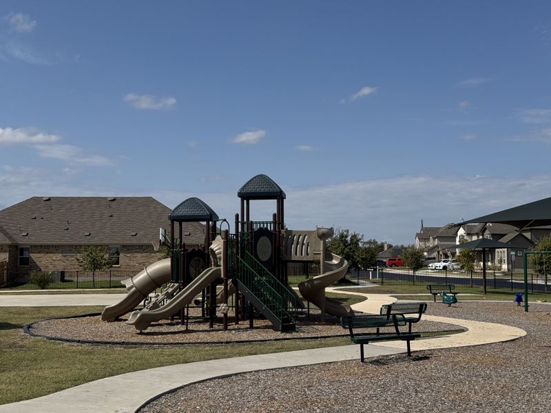 A family-friendly playground with slides and benches in Highlands North by Brightland Homes (Hutto, TX). A family-friendly playground with slides and benches in Highlands North by Brightland Homes (Hutto, TX).