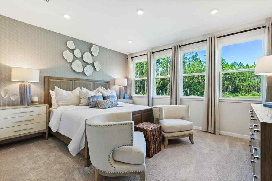 A bedroom with a bed and chairs. A bedroom with a bed and chairs.