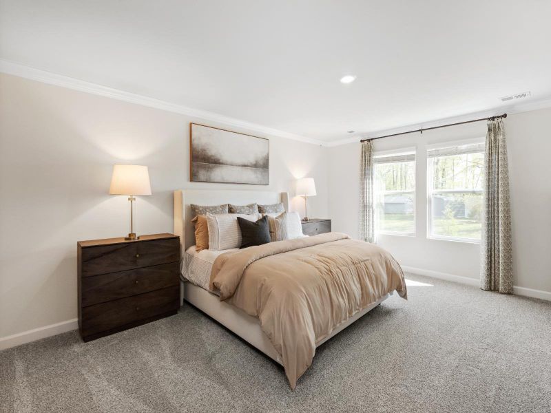 Rest and unwind in the spacious primary bedroom.