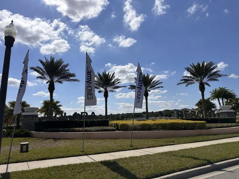 he grand entrance to Solara Resort, lined with palm trees and banners in Solara Resort by Mattamy Homes (Kissimmee, FL).