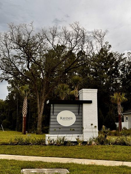 A welcoming sign amidst lush greenery at RiverTown - Ravines by Mattamy Homes in St. Johns, FL.