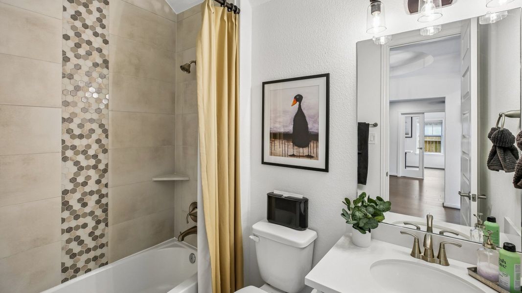 Luxurious bathroom features chic hexagonal tiles and premium fixtures in the Cypress Green community. Luxurious bathroom features chic hexagonal tiles and premium fixtures in the Cypress Green community.