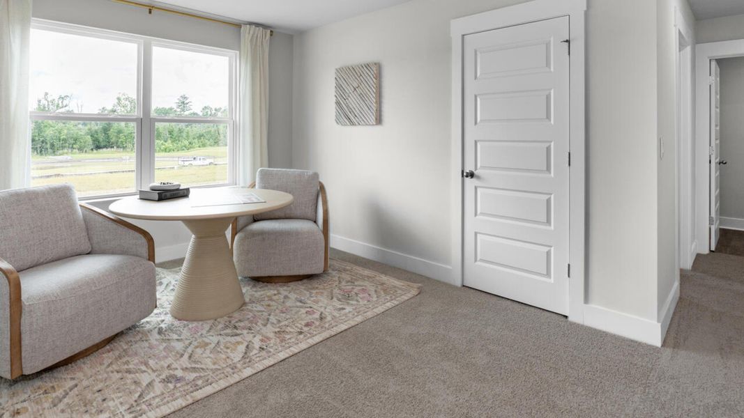 Furnished interior in a model home at Eagle Creek in Bolivia (Image 34).