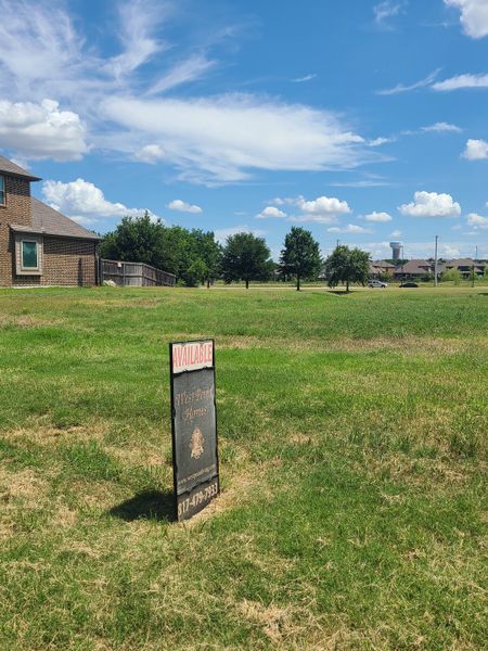 A future homesite with lush greenery and bright skies in Riverdance by West Point Homes (Keller, TX).