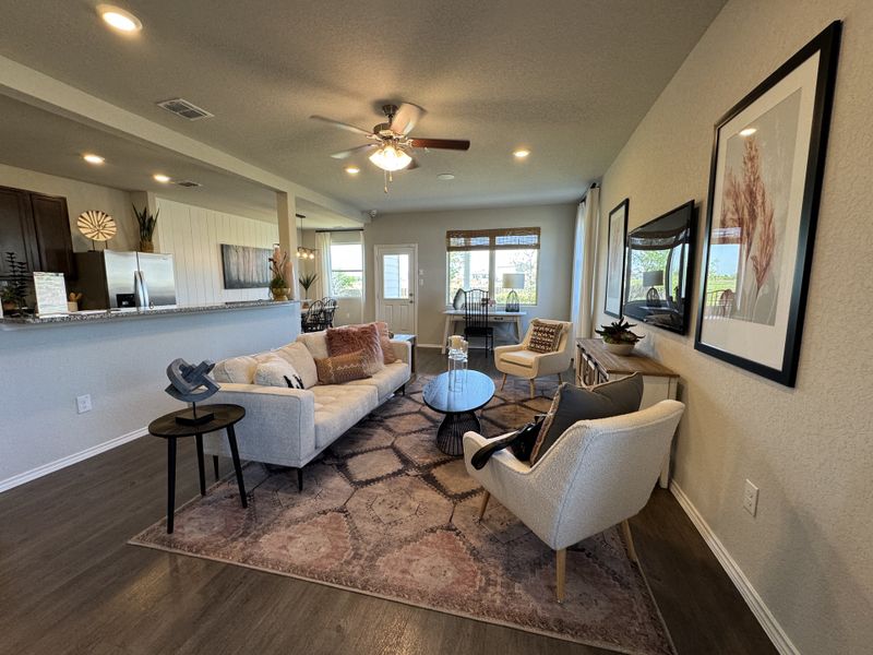 A cozy living room featuring a neutral-toned sofa, stylish artwork, and open layout with ample natural light.