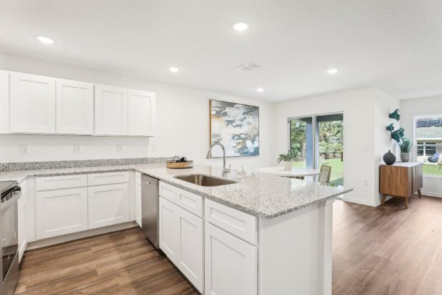 A kitchen with white cabinets.