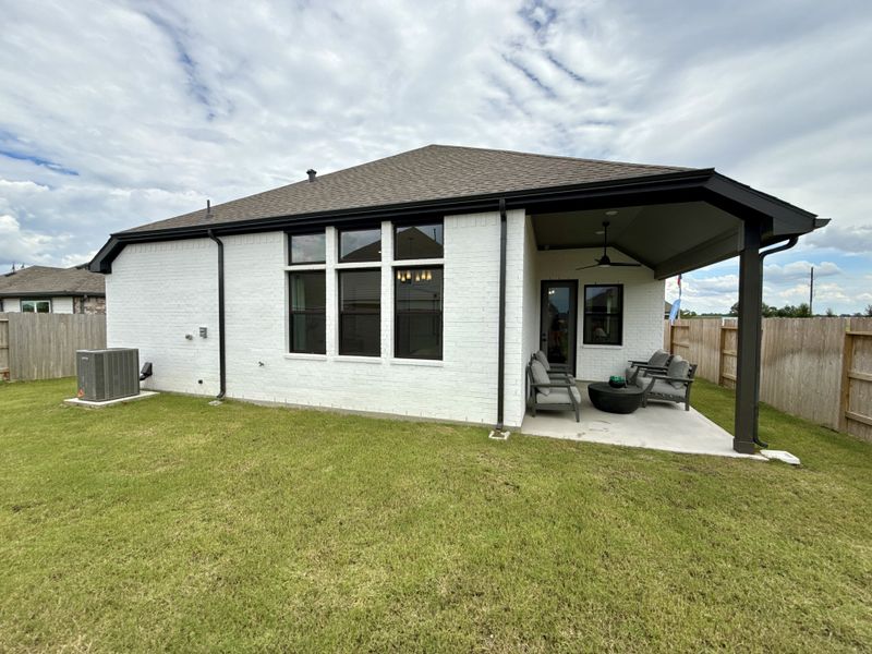 A charming white brick home with a spacious patio in Oakwood Estates by Brightland Homes (Waller, TX). A charming white brick home with a spacious patio in Oakwood Estates by Brightland Homes (Waller, TX).