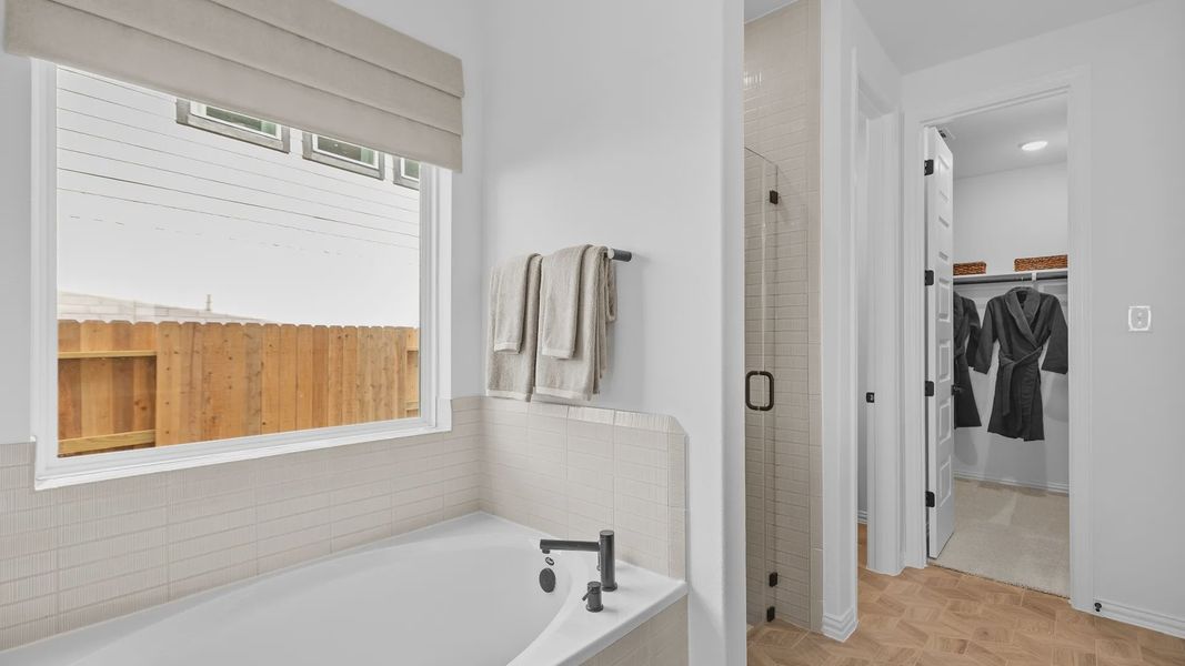 Luxurious tub and glass-enclosed shower with exquisite tilework in River Ranch. Luxurious tub and glass-enclosed shower with exquisite tilework in River Ranch.