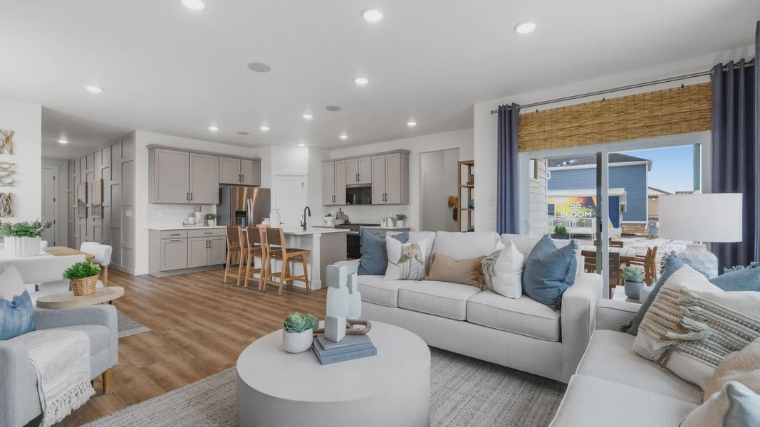 Elegant kitchen island, plush seating, and wood finishes enhance luxury in this Bloom, Colorado home.