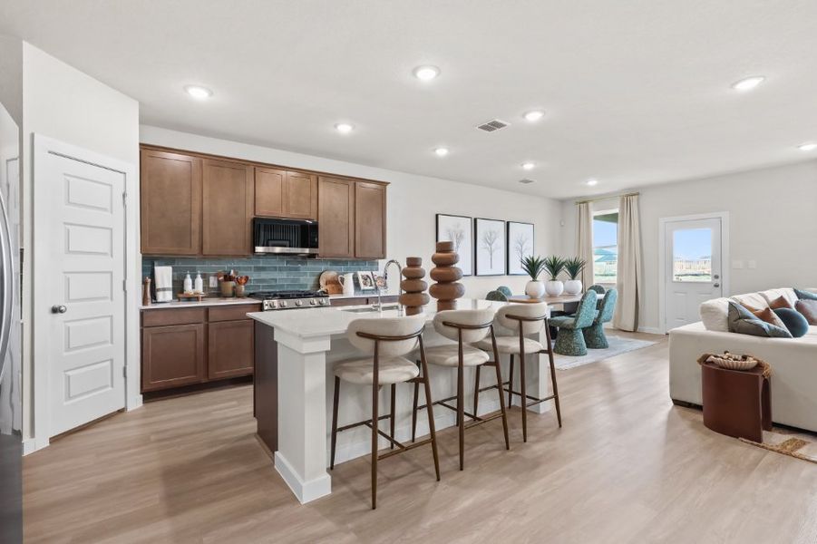 A kitchen with a dining table and chairs. A kitchen with a dining table and chairs.