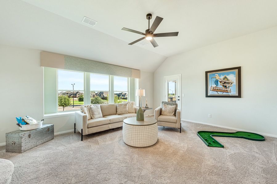 Bonus room with vaulted ceiling, ceiling fan, carpet, and large windows overlooking neighborhood Bonus room with vaulted ceiling, ceiling fan, carpet, and large windows overlooking neighborhood