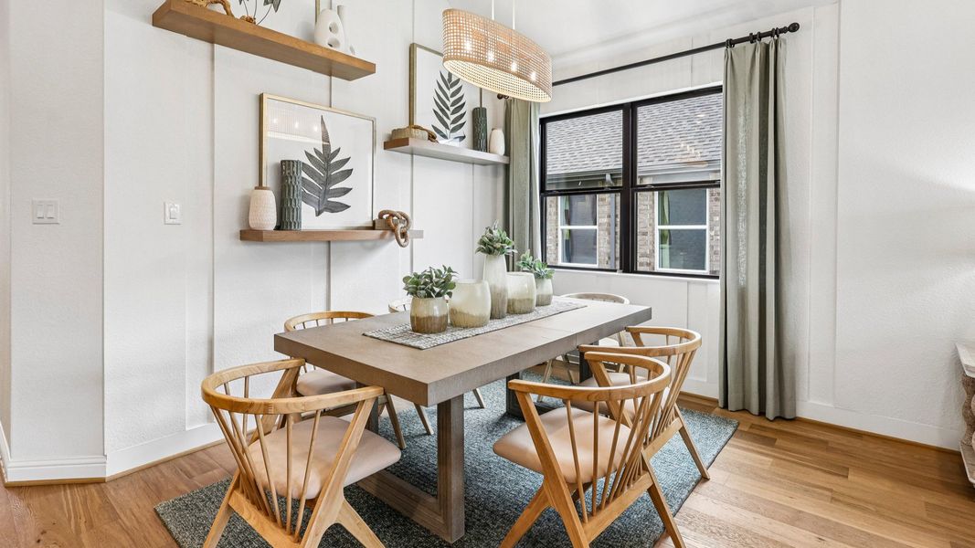 Sophisticated dining area features minimalist design, sleek wooden furniture, modern light fixture in Sunterra. Sophisticated dining area features minimalist design, sleek wooden furniture, modern light fixture in Sunterra.