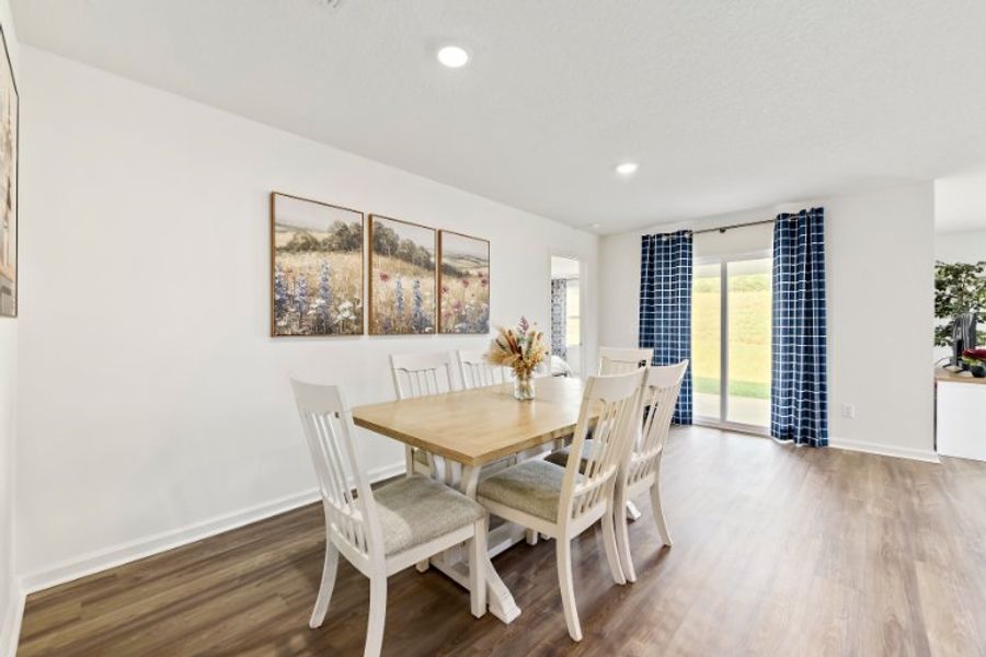 A dining room with a table and chairs. A dining room with a table and chairs.
