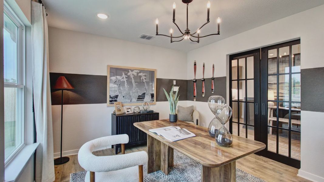 Experience refined elegance with sleek glass doors and designer chandelier in Prairie Green's office space.