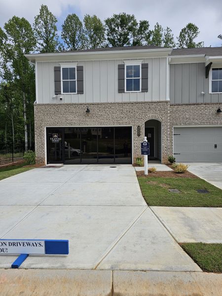 A charming two-story home with a brick facade and manicured lawn in Wildwood Place by Traton Homes (Powder Springs, GA). A charming two-story home with a brick facade and manicured lawn in Wildwood Place by Traton Homes (Powder Springs, GA).