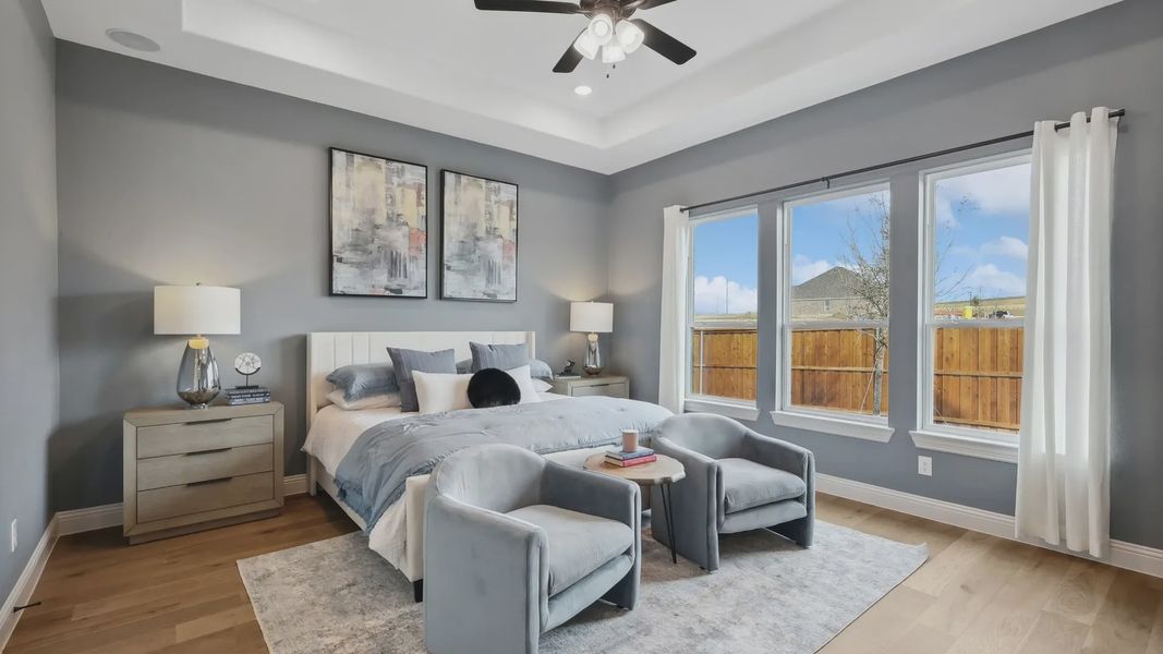 Elegant tray ceiling and expansive windows illuminate this Westside Preserve sanctuary, featuring upscale modern decor.