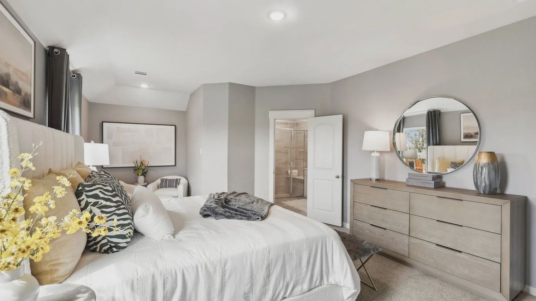 Exquisite neutral palette bedroom with upscale finishes. Features include a sleek dresser and plush textiles. Located in Still Water Lake Estates.