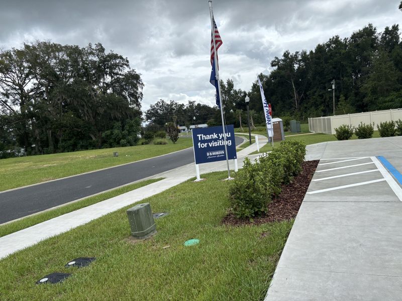 A welcoming drive with lush greenery in Autumn Glen by D.R. Horton, Belleview, FL.