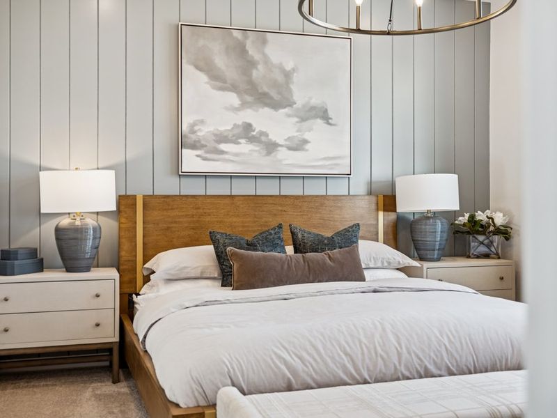 A bedroom with a large picture on the wall.