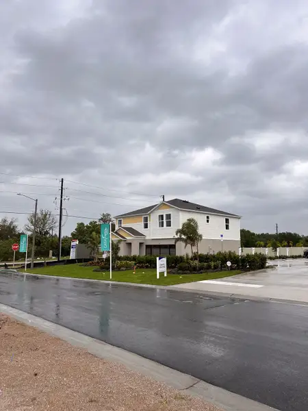 A modern two-story home with a landscaped yard in Bradbury Creek by Casa Fresca Homes, located in Haines City, FL.